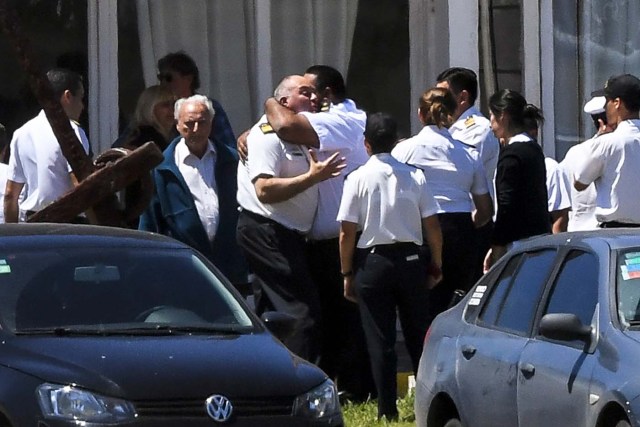 Relatives and comrades of 44 crew members of Argentine missing submarine, express their grief at Argentina's Navy base in Mar del Plata, on the Atlantic coast south of Buenos Aires, on November 23, 2017. An unusual noise heard in the ocean near the last known position of the San Juan submarine was "consistent with an explosion," Argentina's navy announced Thursday. "An anomalous, singular, short, violent and non-nuclear event consistent with an explosion," occurred shortly after the last communication of the San Juan and its 44 crew, navy spokesman Captain Enrique Baldi told a news conference in Buenos Aires. / AFP PHOTO / EITAN ABRAMOVICH / BEST QUALITY AVAILABLE