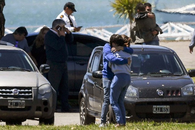 Relatives and comrades of 44 crew members of Argentine missing submarine, express their grief at Argentina's Navy base in Mar del Plata, on the Atlantic coast south of Buenos Aires, on November 23, 2017. An unusual noise heard in the ocean near the last known position of the San Juan submarine was "consistent with an explosion," Argentina's navy announced Thursday. "An anomalous, singular, short, violent and non-nuclear event consistent with an explosion," occurred shortly after the last communication of the San Juan and its 44 crew, navy spokesman Captain Enrique Baldi told a news conference in Buenos Aires. / AFP PHOTO / EITAN ABRAMOVICH / BEST QUALITY AVAILABLE