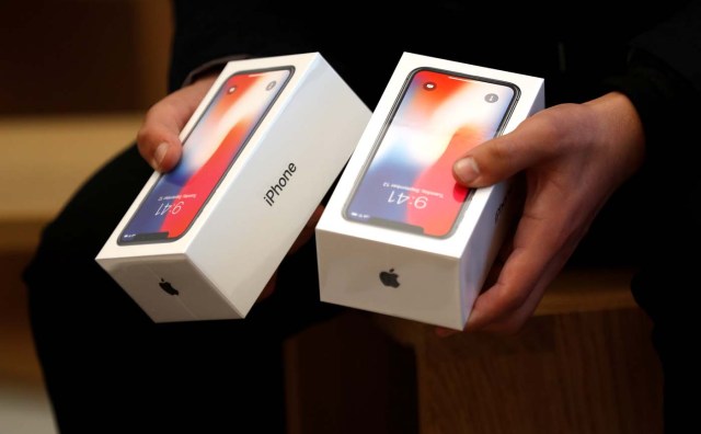 A man holds two boxes for the Apple’s new iPhone X which went on sale today, at the Apple Store in Regents Street in London, Britain, November 3, 2017. REUTERS/Peter Nicholls