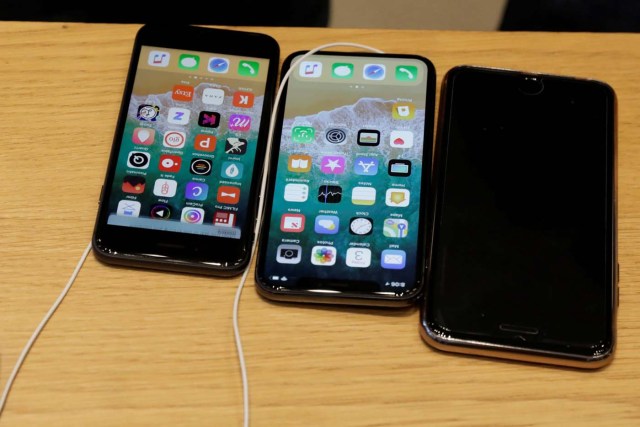 An Apple iPhone X model (C) is seen next to older models of iPhone on a table at an Apple store in New York, U.S., November 3, 2017. REUTERS/Lucas Jackson