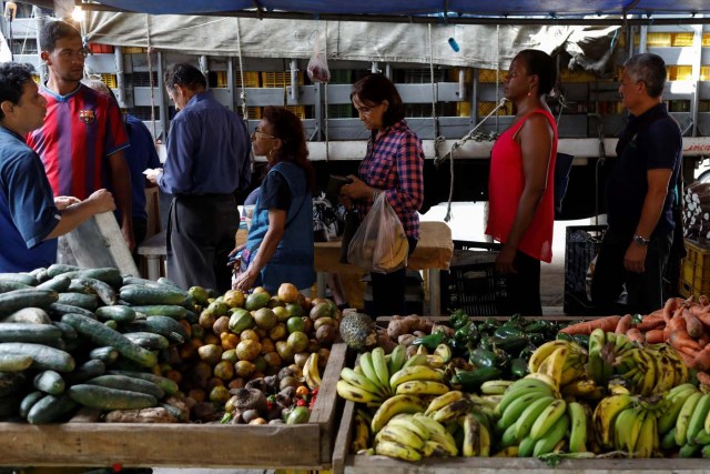 People line up to pay for their fruits and vegetables at a street market in Caracas, Venezuela November 3, 2017. Picture taken November 3, 2017. REUTERS/Marco Bello