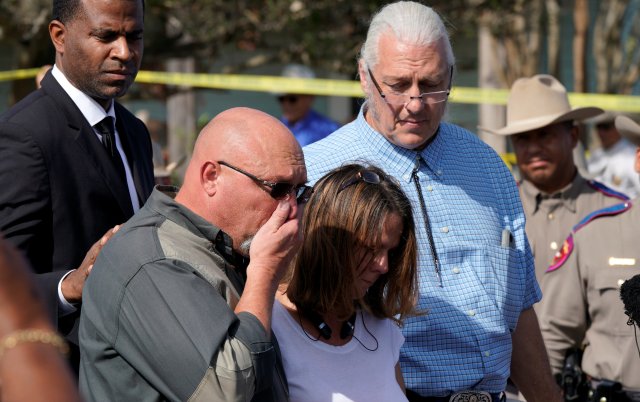 Pastor Frank Pomeroy (2nd L) with his wife Sherri speaking, is comforted at a news conference outside the site of the shooting at his church, the First Baptist Church of Sutherland, Texas, U.S., November 6, 2017. REUTERS/Rick Wilking