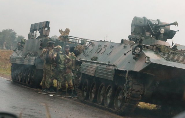 REFILE - CORRECTING TYPO IN SLUG Soldiers stand beside military vehicles just outside Harare,Zimbabwe,November 14,2017. REUTERS/Philimon Bulawayo