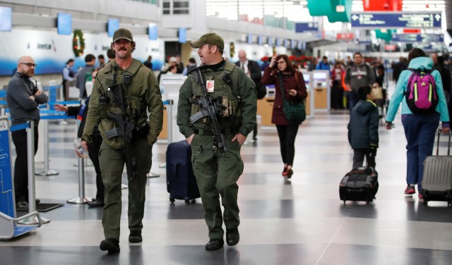Security guards walk through Terminal 3 at O'Hare Airport before the busy Thanksgiving Day weekend in Chicago, Illinois, U.S., November 21, 2017. REUTERS/Kamil Krzaczynski