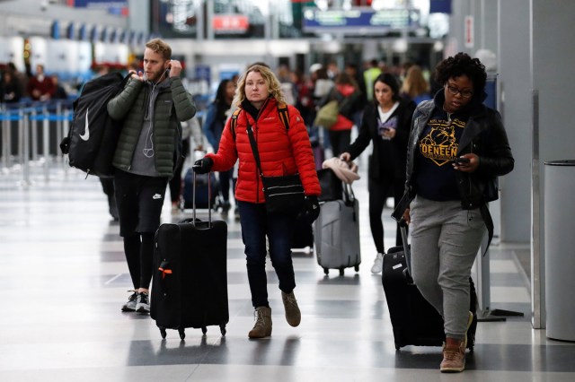 Travelers walk through Terminal 3 at O'Hare Airport before the busy Thanksgiving Day weekend in Chicago, Illinois, U.S., November 21, 2017. REUTERS/Kamil Krzaczynski