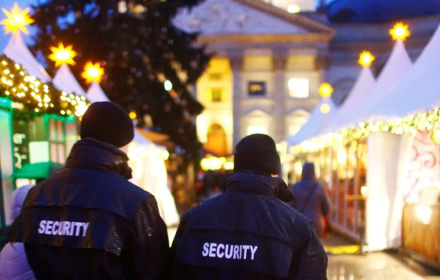 Security guards walk over the Christmas market at Gendarmenmarkt square in Berlin, Germany, November 27, 2017. REUTERS/Hannibal Hanschke