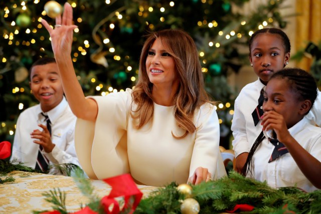 U.S. First Lady Melania Trump playfully tosses a Christmas ball to school children making crafts as she tours the holiday decorations with reporters at the White House in Washington, U.S. November 27, 2017. REUTERS/Jonathan Ernst