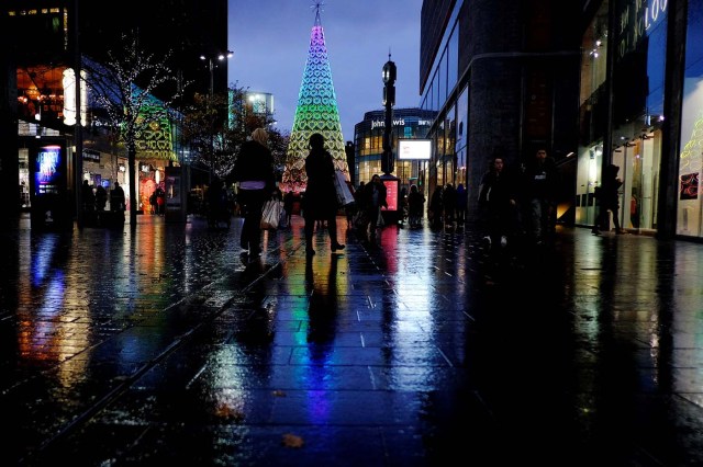 Shoppers walk past an illuminated Christmas tree in Liverpool, Britain, November 27, 2017. REUTERS/Phil Noble