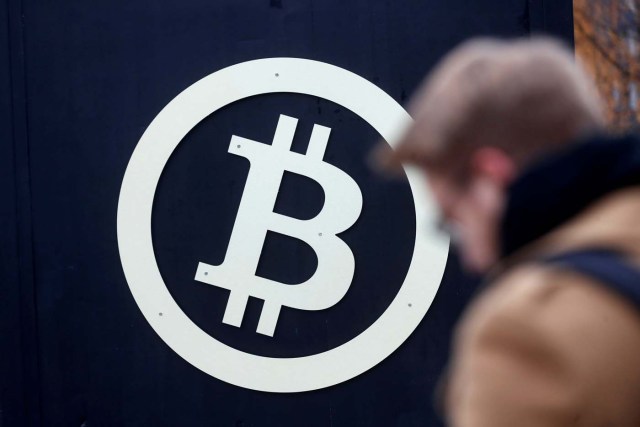 FILE PHOTO: A bitcoin sign is seen during Riga Comm 2017, a business technology and innovation fair in Riga, Latvia November 9, 2017. REUTERS/Ints Kalnins/File Photo