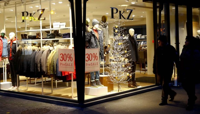 A poster offers 30 percent pre-sale discount are seen beside christmas decoration in a window of a PKZ clothing store at the Bahnhofstrasse shopping street in Zurich, Switzerland, November 27, 2017. REUTERS/Arnd Wiegmann