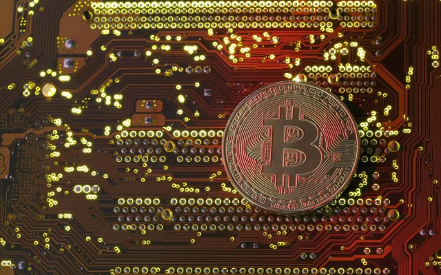 FILE PHOTO: A copy of bitcoin standing on PC motherboard is seen in this illustration picture, October 26, 2017.   REUTERS/Dado Ruvic/File Photo
