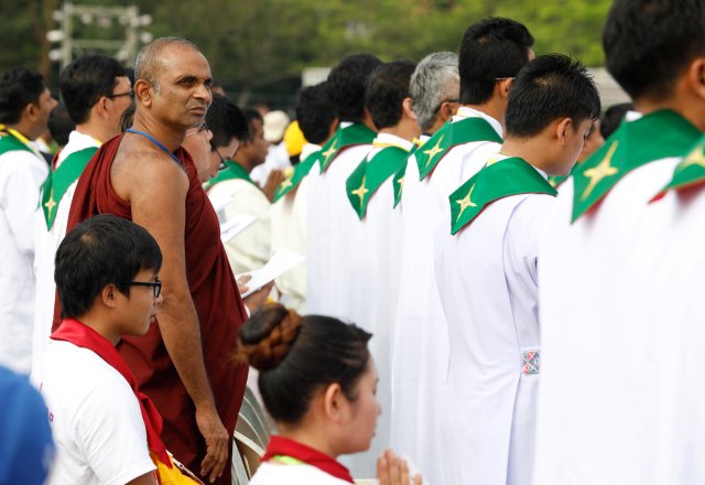 Faithful attend a mass led by Pope Francis at Kyite Ka San Football Stadium in Yangon, Myanmar November 29, 2017. REUTERS/Ann Wang NO RESALES. NO ARCHIVES.