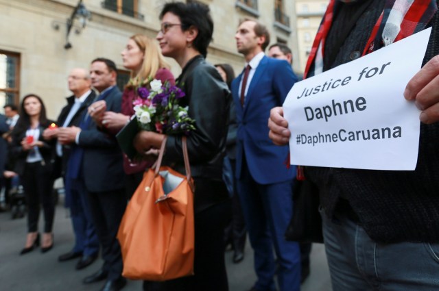 epa06273950 European journalists joined by EU commissioner during a silent vigil in memory of Maltese journalist Daphne Caruana Galizia in Brussels Belgium, 18 October 2017. Daphne Caruana Galizia, 53, was killed in a car bombing near Mosta , Malta on 16 October . She was known for her blog accusing top politicians of corruption. EPA/OLIVIER HOSLET