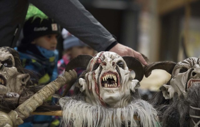 A mask of a participant is seen prior the procession of 'Krampus' monsters in Schwadorf, Austria, on November 24, 2017. Krampus is traditionally the evil sidekick of Santa, sent to frighten naughty children and "evil spirits" in the run-up for Christmas. / AFP PHOTO / ALEX HALADA