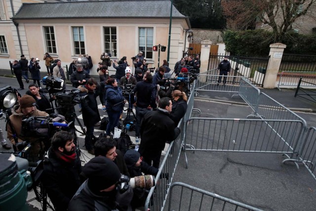 Journalists work in front of late French singer and actor Johnny Hallyday's home in Marnes-la-Coquette near Paris, France December 6, 2017. REUTERS/Benoit Tessier