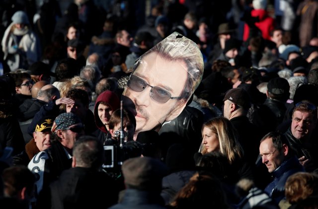 Fans gather on the Champs Elysees avenue during a 'popular tribute' to late French singer and actor Johnny Hallyday in Paris, France, December 9, 2017. REUTERS/Benoit Tessier
