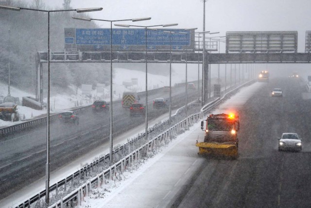 A road gritting vehicle treats the M1 motorway as the snow falls near Kegworth, Britain, December 10, 2017. REUTERS/Darren Staples
