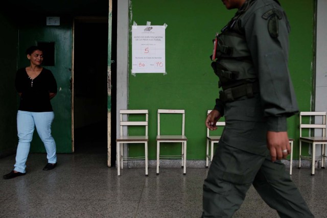 A woman walks out a polling station during a nationwide election for new mayors, in Caracas, Venezuela December 10, 2017. REUTERS/Fabiola Ferrero