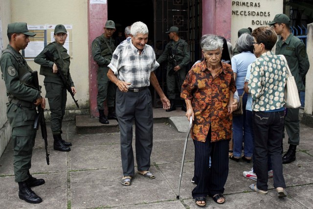 People walk out from a polling station during a nationwide election for new mayors, in Rubio, Venezuela December 10, 2017. REUTERS/Carlos Eduardo Ramirez