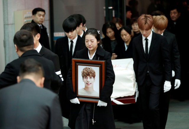 A portrait and the coffin of Kim Jong-hyun, the lead singer of top South Korean boy band SHINee, is carried during his funeral at a hospital in Seoul, South Korea, December 21, 2017. REUTERS/Kim Hong-Ji TPX IMAGES OF THE DAY