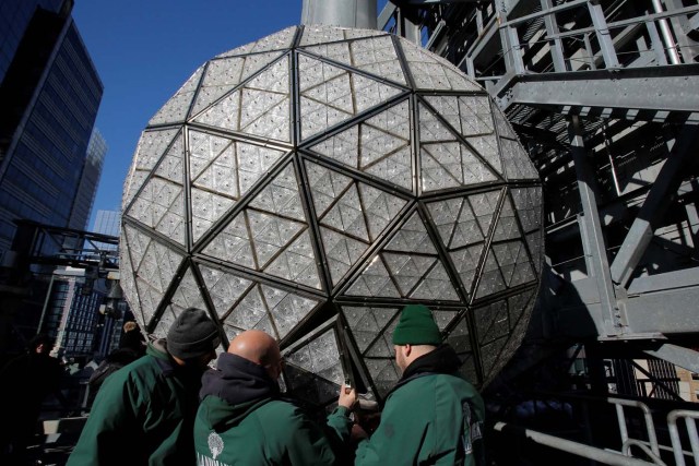 Workers install Waterford Crystal triangles on the Times Square New Year's Eve Ball on the roof of One Times Square in Manhattan, New York, U.S., December 27, 2017. REUTERS/Andrew Kelly