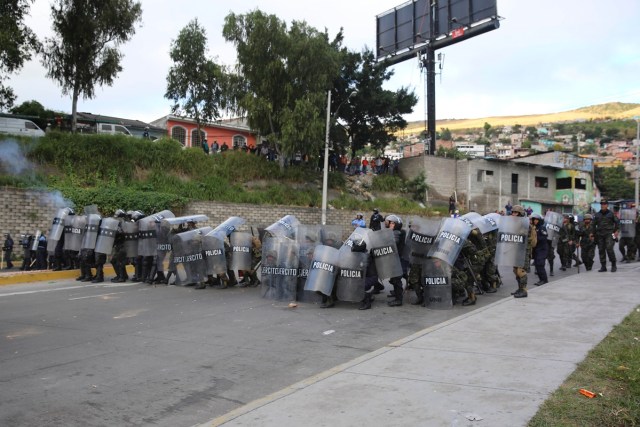 TGP06. TEGUCIGALPA (HONDURAS) 15/12/2017.- Decenas de policías hondureños se enfrentan con un grupo de manifestantes hoy, viernes 15 de diciembre de 2017, en Tegucigalpa (Honduras). Cientos de manifestantes bloquearon hoy importantes carreteras en las principales ciudades de Honduras en protesta por el presunto "fraude" en los comicios del 26 de noviembre contra el candidato de la Alianza de Oposición contra la Dictadura, Salvador Nasralla. EFE/Gustavo Amador