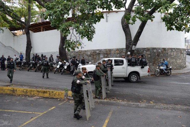 Security forces block access to the morgue in Caracas where the bodies of rogue pilot Oscar Perez and six other "terrorists" killed during a bloody police assault to arrest them, are being kept on January 17, 2018. Venezuela's government announced Tuesday that Perez was among seven "terrorists" killed when police swooped on them outside Caracas on Monday, setting off a fierce gunbattle in which two police officers were also killed. Perez had been wanted since he used a stolen helicopter to bomb Venezuela's Supreme Court at the height of anti-government protests last June. / AFP PHOTO / Federico PARRA
