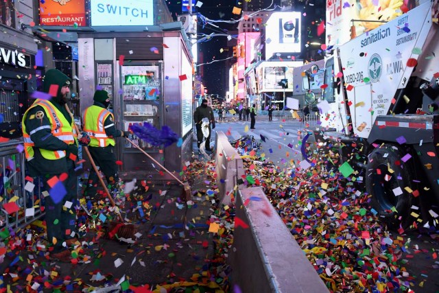 NYC sanitation workers clean up confetti following New Year celebrations in Times Square in Manhattan, New York, U.S., January 1, 2018. REUTERS/Darren Ornitz