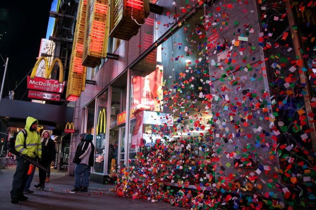 A New York City Department of Sanitation worker cleans the streets after the New Year celebrations in Times Square in Manhattan, New York, U.S., January 1, 2018. REUTERS/Amr Alfiky