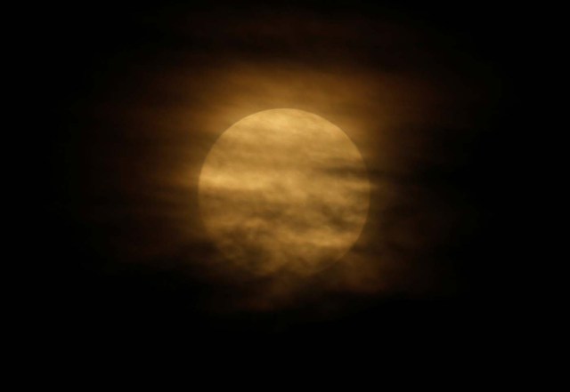 A 'supermoon' full moon is partly obscured by clouds in Pieta, Malta, January 1, 2018. REUTERS/Darrin Zammit Lupi