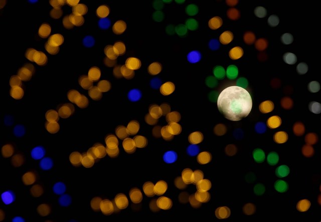 The 'supermoon' full moon is seen through Christmas lights in Valletta, Malta, January 1, 2018. REUTERS/Darrin Zammit Lupi