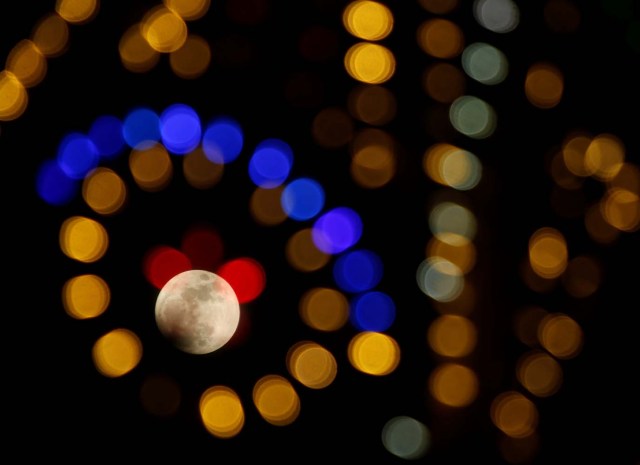 The 'supermoon' full moon is seen through Christmas lights in Valletta, Malta, January 1, 2018. REUTERS/Darrin Zammit Lupi