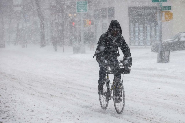 A man rides a bike in the wind and snow during a snowstorm in the Brooklyn borough of New York City, U.S., January 4, 2018. REUTERS/Brendan McDermid