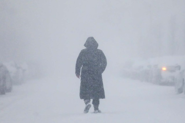 A woman walks down the street during a blizzard in Long Beach, New York, U.S. January 4, 2018. REUTERS/Shannon Stapleton TPX IMAGES OF THE DAY