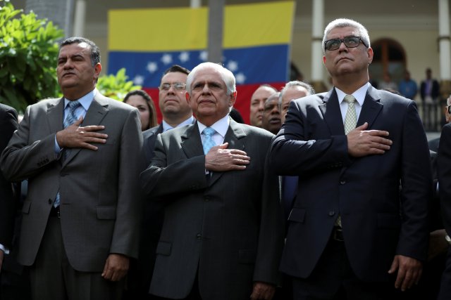 Julio Cesar Reyes, first vice president, Omar Barboza, president of the National Assembly and Alfonso Marquina, second vice president, listens the national anthem after a session of the National Assembly in Caracas, Venezuela January 5, 2018. REUTERS/Marco Bello