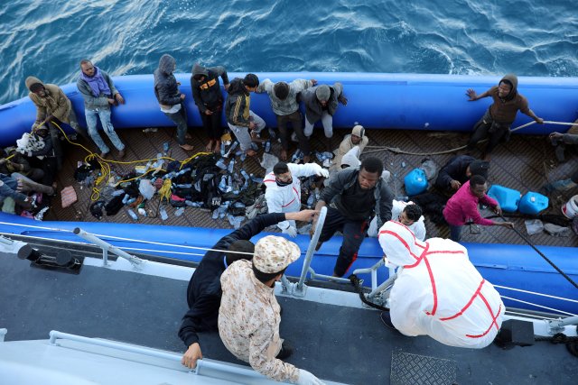 Migrants in a dinghy are rescued by Libyan coast guards off the coast of Garabulli, east of Tripoli, Libya, January 8, 2018. REUTERS/Hani Amara
