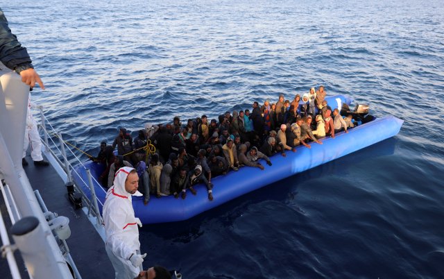 Migrants in a dinghy are rescued by Libyan coast guards off the coast of Garabulli, east of Tripoli, Libya, January 8, 2018. REUTERS/Hani Amara