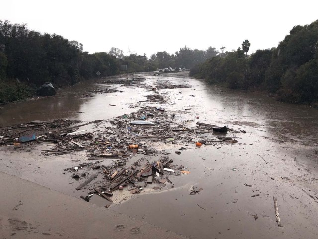 Debris floats in flooded waters on the freeway after a mudslide in Montecito, California, U.S. in this photo provided by the Santa Barbara County Fire Department, January 9, 2018. Mike Eliason/Santa Barbara County Fire Department/Handout via REUTERS ATTENTION EDITORS - THIS IMAGE WAS PROVIDED BY A THIRD PARTY.