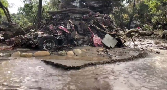 A vehicle is wrapped around a tree after flood and mudslides in Montecito, California, U.S. January 9, 2018 in this photo obtained from social media. Santa Barbara County Fire Department/via REUTERS THIS IMAGE HAS BEEN SUPPLIED BY A THIRD PARTY. MANDATORY CREDIT. NO RESALES. NO ARCHIVES