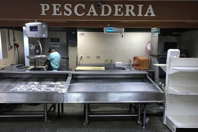 Empty refrigerators are seen at the fish area in a supermarket in Caracas, Venezuela January 10, 2018. REUTERS/Marco Bello