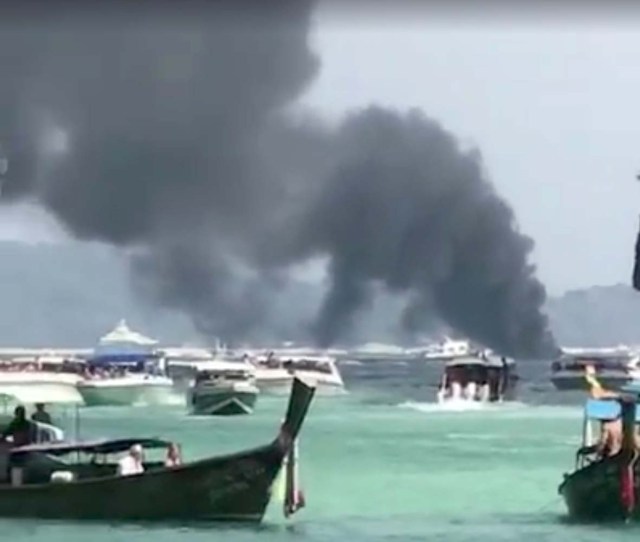 Smoke rises from a tourist speedboat after its explosion in Phi Phi Islands, Thailand, January 14, 2018 in this still image taken from a video obtained from social media. FACEBOOK/THOTSAPHON PHANOMTARA/via REUTERS THIS IMAGE HAS BEEN SUPPLIED BY A THIRD PARTY. MANDATORY CREDIT. NO RESALES. NO ARCHIVES