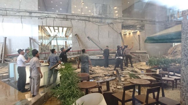 Workers and security examine the damage after a mezzanine floor collapsed at the Indonesia Stock Exchange building in Jakarta, Indonesia January 15, 2018 in this photo taken by Antara Foto. Antara Foto/Elo via REUTERS ATTENTION EDITORS - THIS IMAGE WAS PROVIDED BY A THIRD PARTY. MANDATORY CREDIT. INDONESIA OUT. NO COMMERCIAL OR EDITORIAL SALES IN INDONESIA.