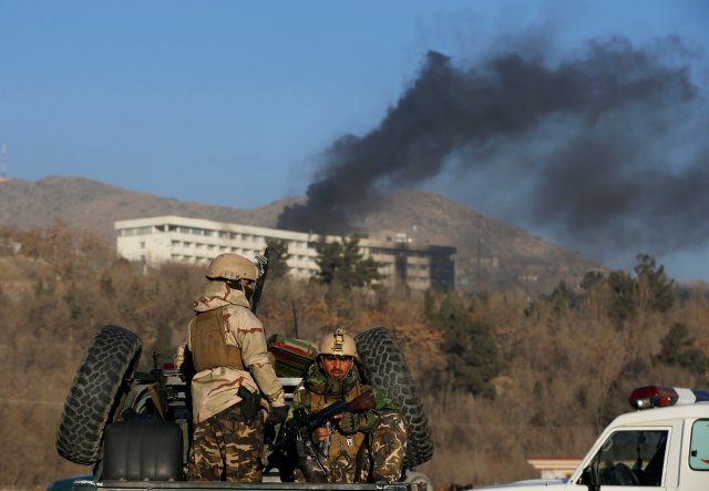 Afghan security forces keep watch as smoke rises from the Intercontinental Hotel in Kabul,ÊAfghanistanÊJanuary 21, 2018. REUTERS/Omar Sobhani