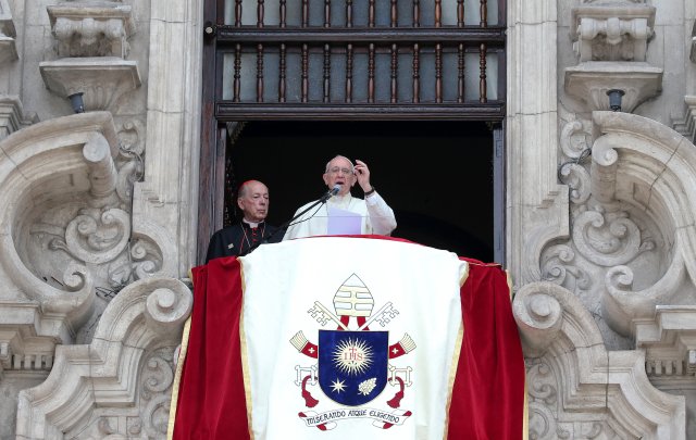 Pope Francis speaks as he is flanked by Archbishop Juan Luis Cipriani during his Angelus prayer from the balcony of the Archbishop's Palace of Lima, Peru, January 21, 2018. REUTERS/Alessandro Bianch