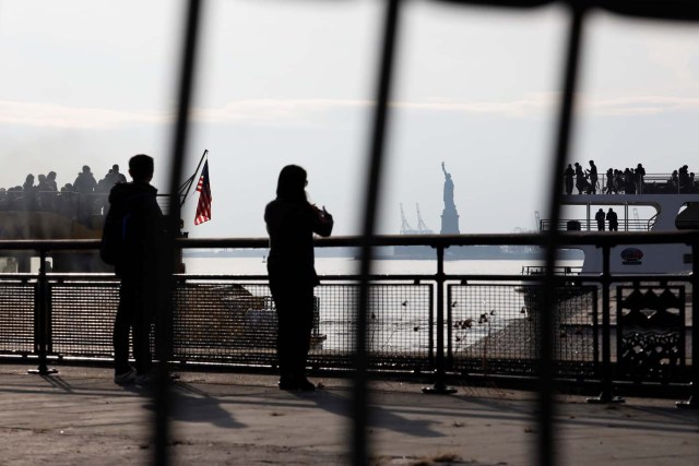 The Statue of Liberty is seen through fencing from a ferry dock following a U.S. government shutdown in Manhattan, New York, U.S., in New York, U.S. January 21, 2018. REUTERS/Shannon Stapleton