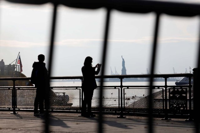 The Statue of Liberty is seen through fencing from a ferry dock following a U.S. government shutdown in Manhattan, New York, U.S., in New York, U.S. January 21, 2018. REUTERS/Shannon Stapleton TPX IMAGES OF THE DAY