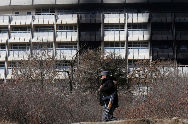 An Afghan policeman walks in front of the Intercontinental Hotel a day after an attack in Kabul, Afghanistan January 22, 2018. REUTERS/Omar Sobhani