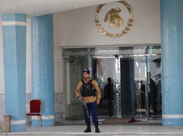 An Afghan security guard stands at the entrance gate of the Intercontinental Hotel after an attack in Kabul, Afghanistan January 23, 2018.REUTERS/Mohammad Ismail