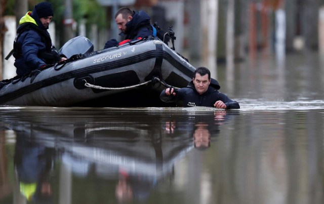 Paris police divers use a small boat to patrol a flooded street of a residential area in Villeneuve-Saint-Georges, near Paris, France January 25, 2018. REUTERS/Christian Hartmann