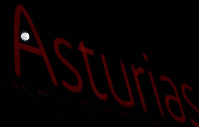 A full moon 'super moon' is seen through a luminous sign with the name of the region "Asturias" in Siero, Spain, January 30, 2018. REUTERS/Eloy Alonso
